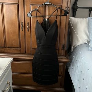 Black dress, laced back with cutout on lower back. ribbed pattern.